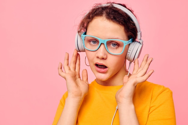 Pretty woman wearing headphones blue glasses closeup emotions isolated backgrounds unaltered