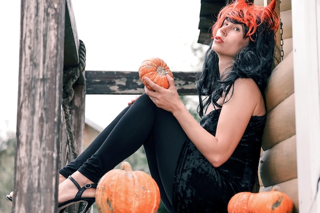 Photo pretty woman in witch costume at halloween party