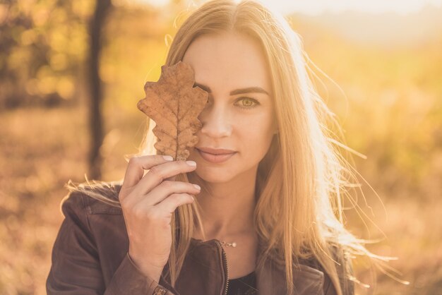 Pretty woman with autumn leaves