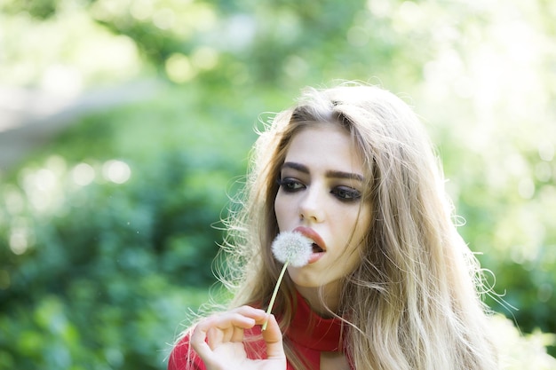 Pretty woman with dandelion