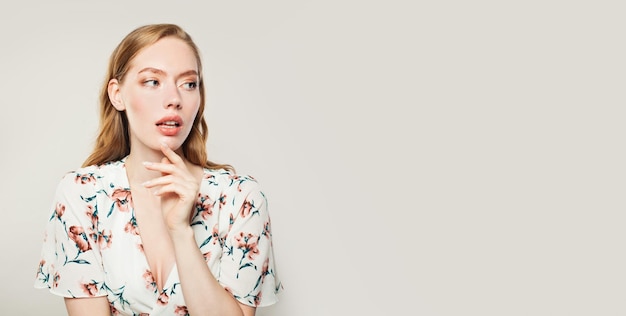 Pretty woman with ginger hair on white background