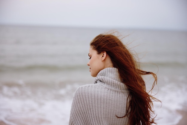 Pretty woman with long hair on the beach nature landscape walk Relaxation concept