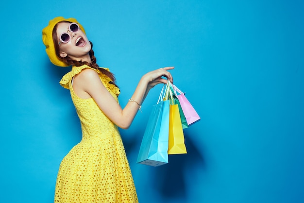 Pretty woman with multicolored bags posing studio model