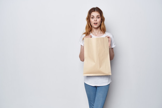 Pretty woman with package of groceries shopping delivery\
lifestyle