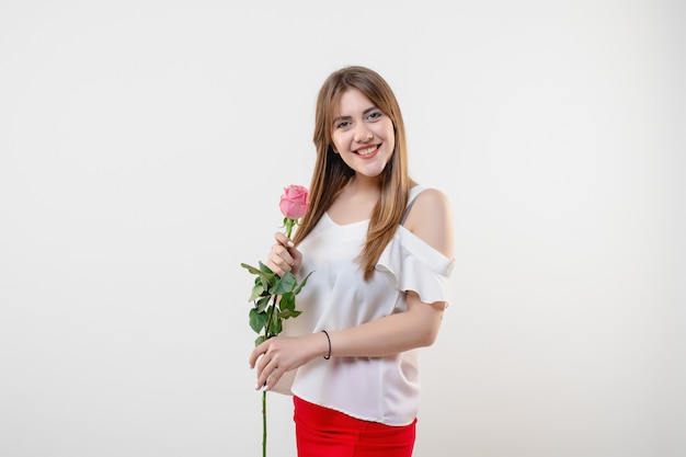 Pretty woman with pink rose isolated