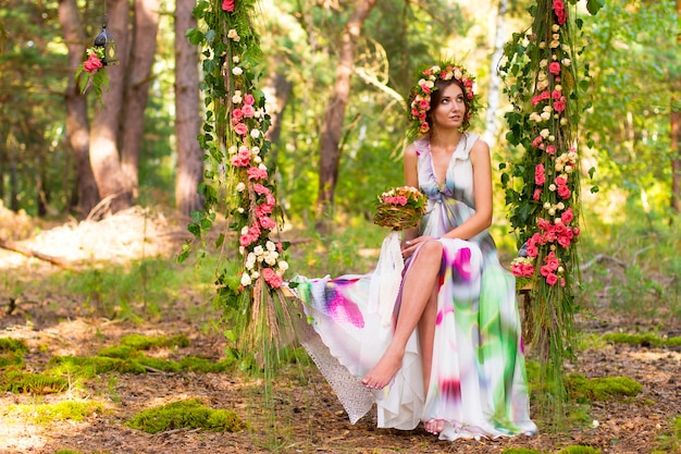 Pretty woman in wreath of flowers.