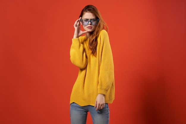 Pretty woman in yellow sweater blue glasses fashion hairstyle