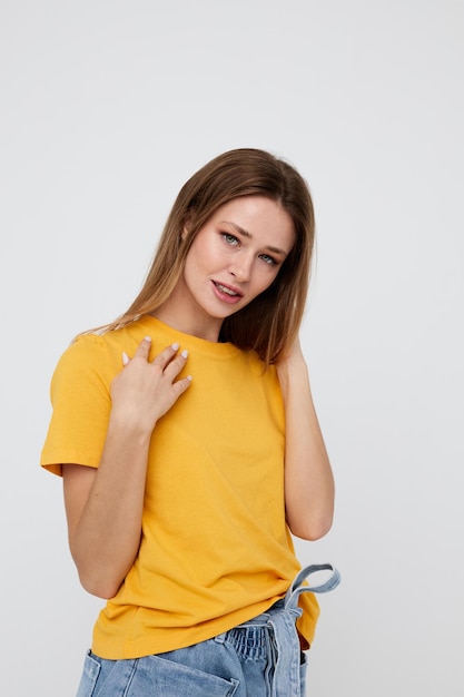 Pretty woman in yellow tshirt red hair posing