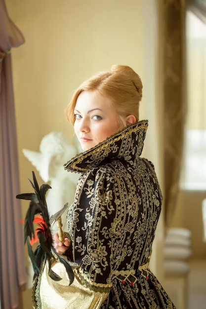 Pretty young actress posing in luxury dress