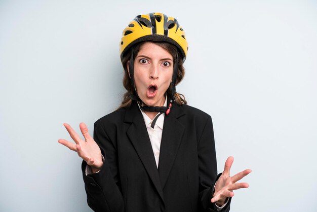 Pretty young adult businesswoman with a bike helmet