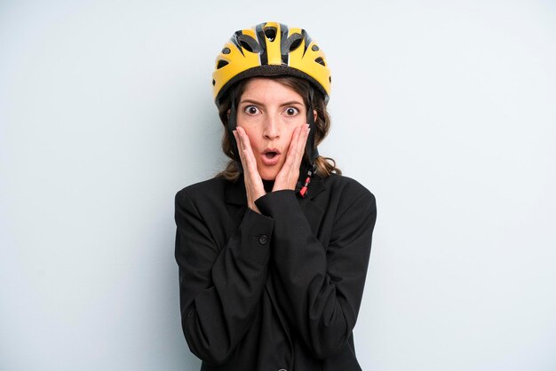 Pretty young adult businesswoman with a bike helmet