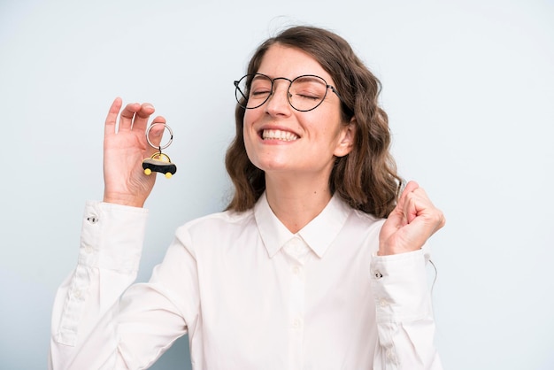 Pretty young adult woman with a car key