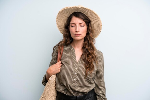 Pretty young adult woman with a hat summer concept