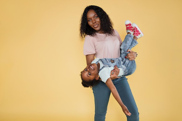 Pretty young African woman have fun with cute child baby girl 34 years old