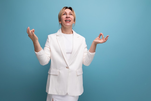 Pretty young blond career woman in business style looking up thoughtfully