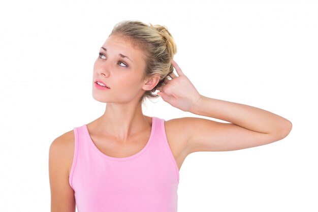 Pretty young blonde in pink looking up