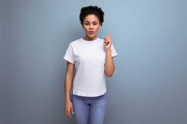 Pretty young brunette hispanic woman in white tshirt is happy to share the news