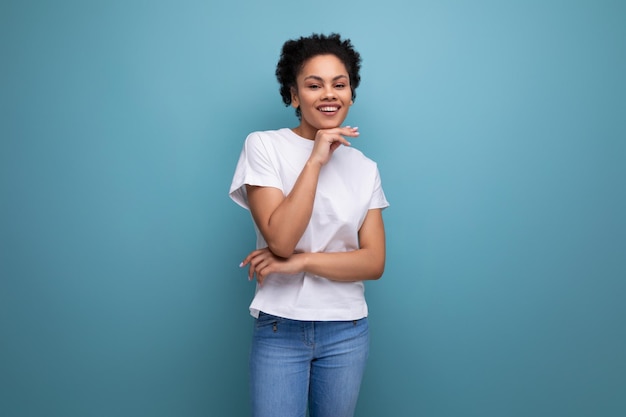 Pretty young brunette hispanic woman in white tshirt isolated with copy space background