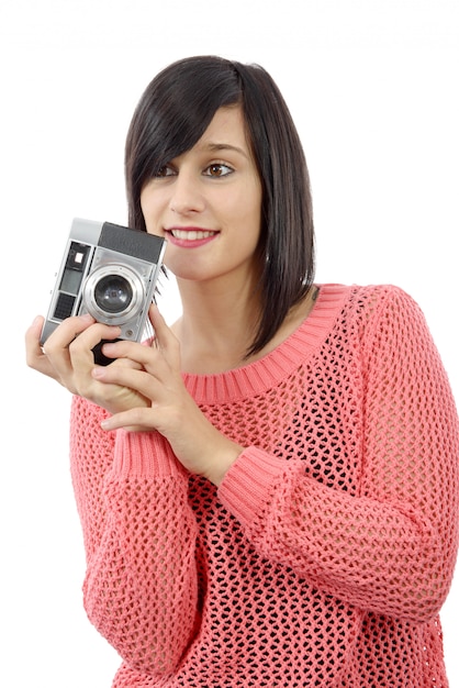 Pretty young brunette woman with an antique camera