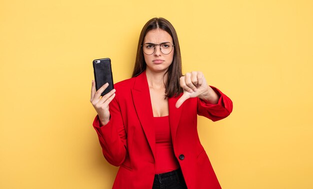 Pretty young businesswoman holding a phone