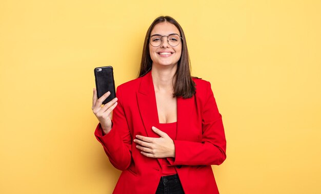 Pretty young businesswoman holding a phone