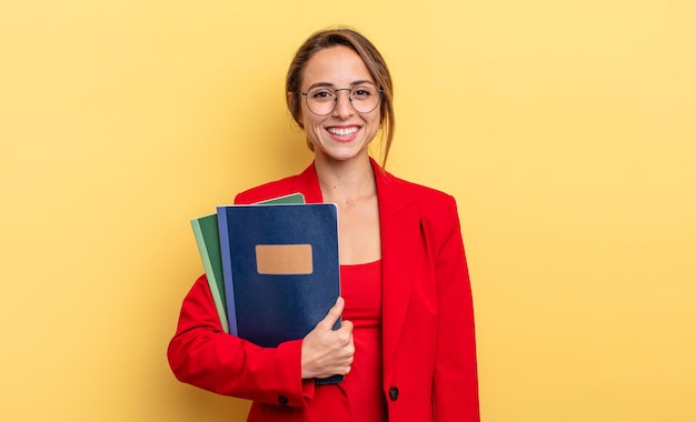 Pretty young businesswoman with books