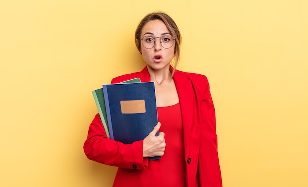 Pretty young businesswoman with books