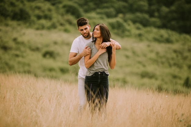 pretty young couple in love outside in spring nature