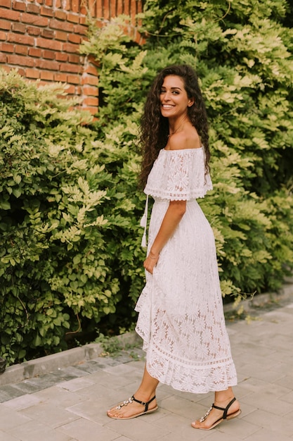 Pretty young curly hair woman in the park