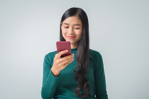 Pretty young female holds smartphone