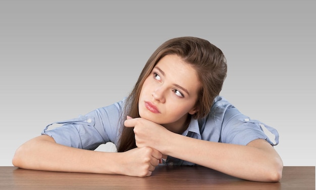 Pretty Young female student thinking   on background