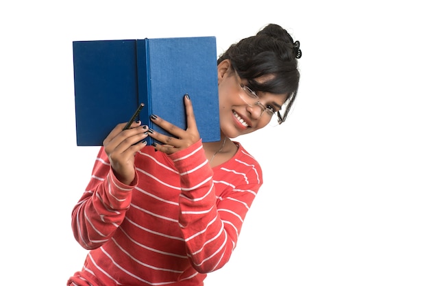 Pretty young girl holding book and posing