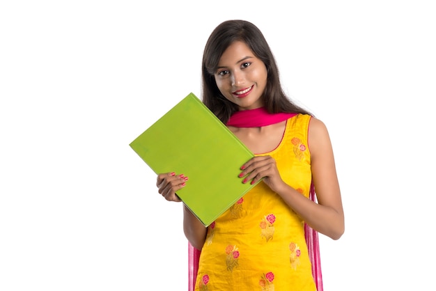 Pretty young girl holding book and posing