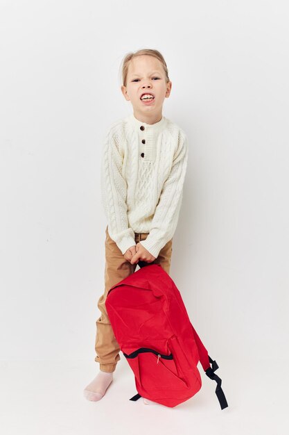 Pretty young girl red backpack stylish clothes isolated background