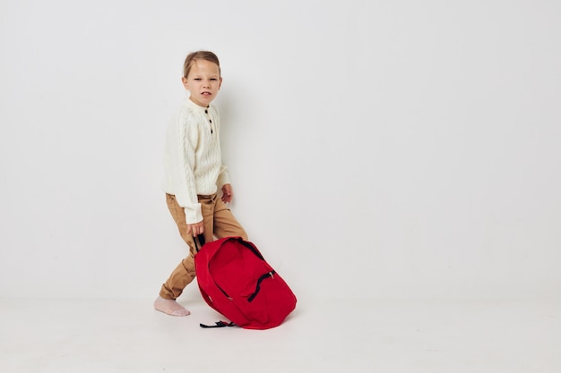 Pretty young girl school red backpack posing isolated background