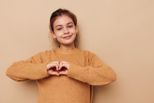 Pretty young girl in sweater posing hand gestures isolated background