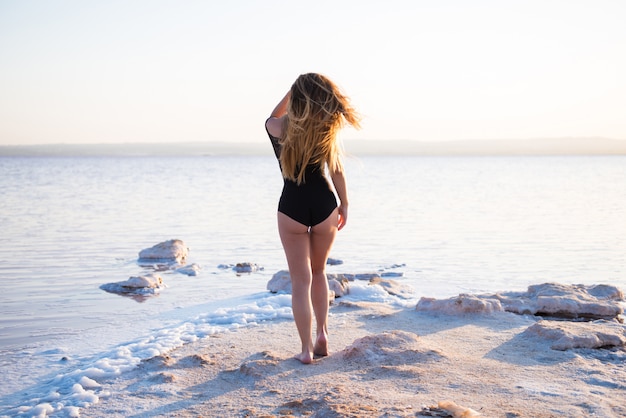 Pretty young girl in swimsuit at the beach