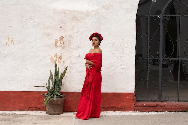 Pretty young girl wearing classical mexican dress red like flamingo