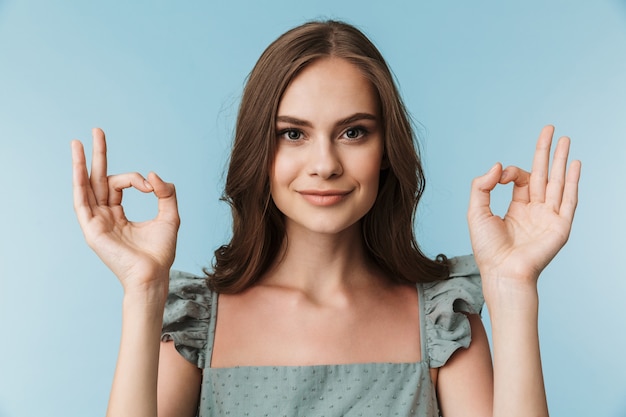 Pretty young lady showing okay gesture.