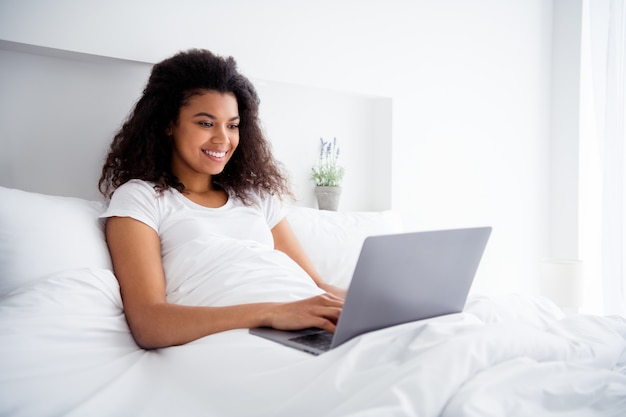 Pretty young lady sitting in bed