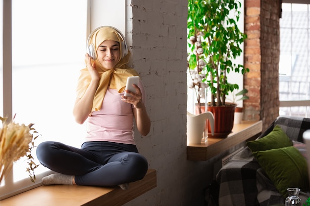 A pretty young muslim woman at home during quarantine and self-insulation