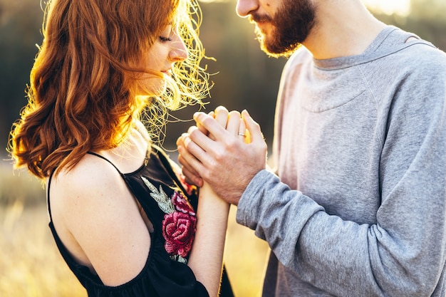 Pretty young romantic couple spend time together outdoor.