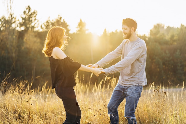 Pretty young romantic couple spend time together outdoor.