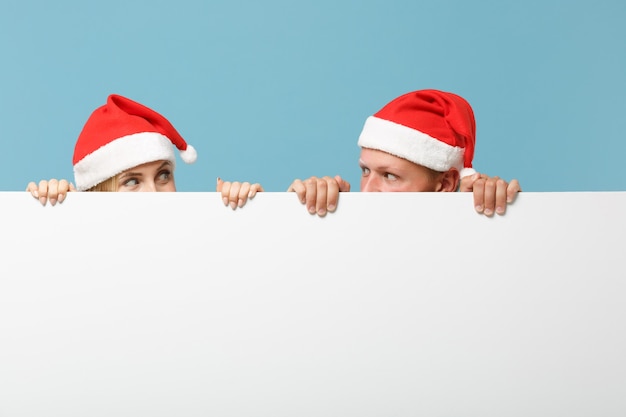 Pretty young Santa couple friends guy and woman in Christmas hat 