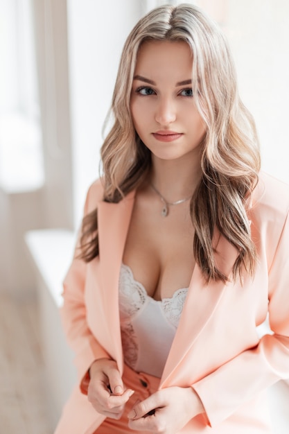 Premium Photo  Pretty young sexy woman in elegant suit with blazer and  white lace underwear bodysuit