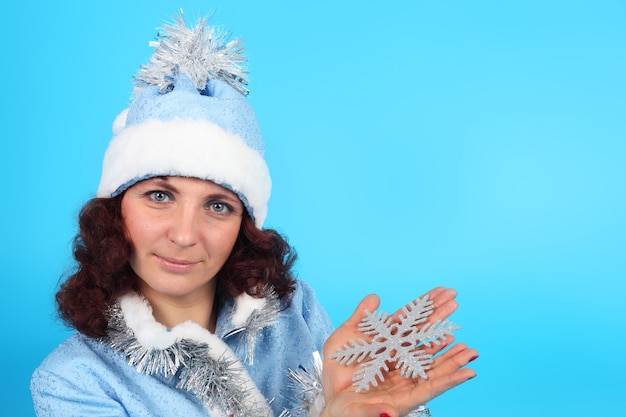 Pretty young Snow Maiden with the snowflake in her hand