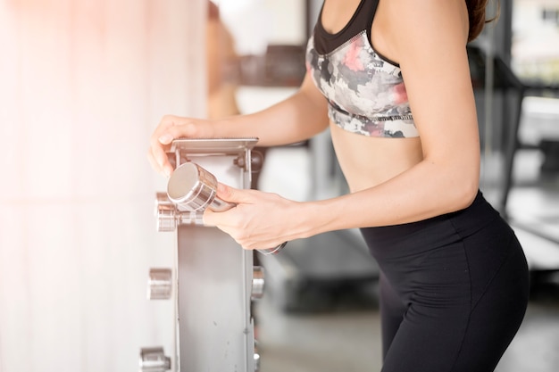 Pretty young sport woman is Workout in gym