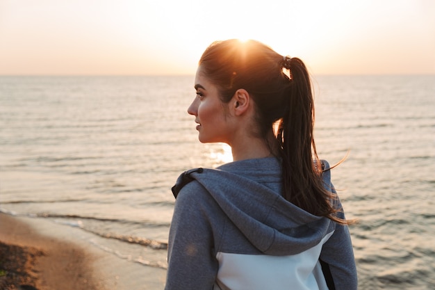 Pretty young sport woman smiling and looking away