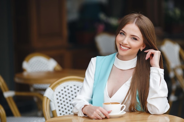 pretty young woman in cafe with coffee