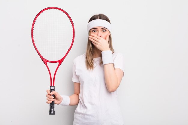 pretty young woman covering mouth with hands with a shocked. tennis concept